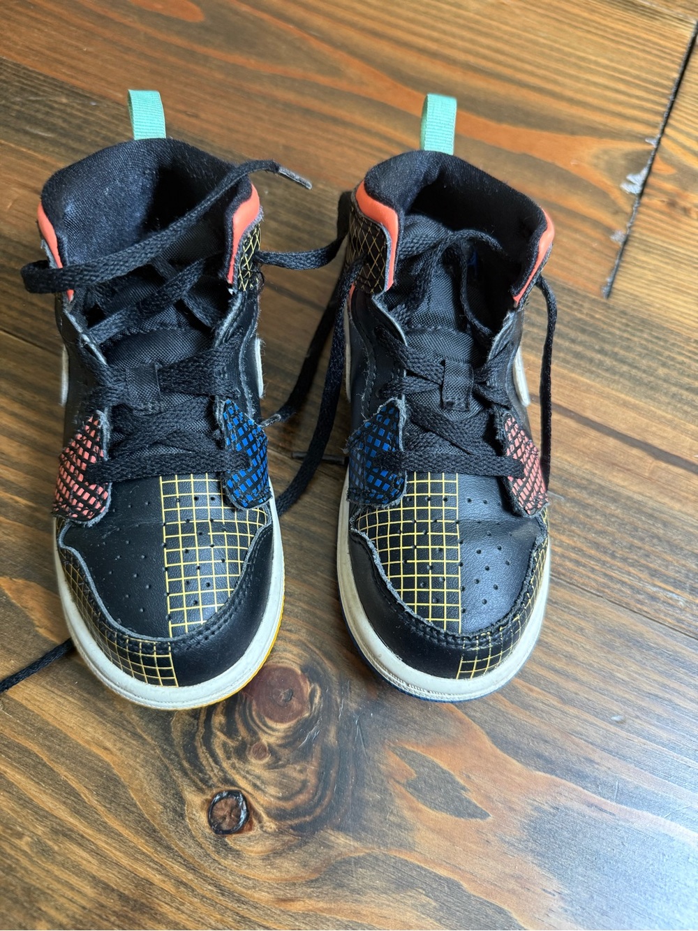 Jordan Kids Black High-Top Sneakers with Blue, Red and Yellow Accents